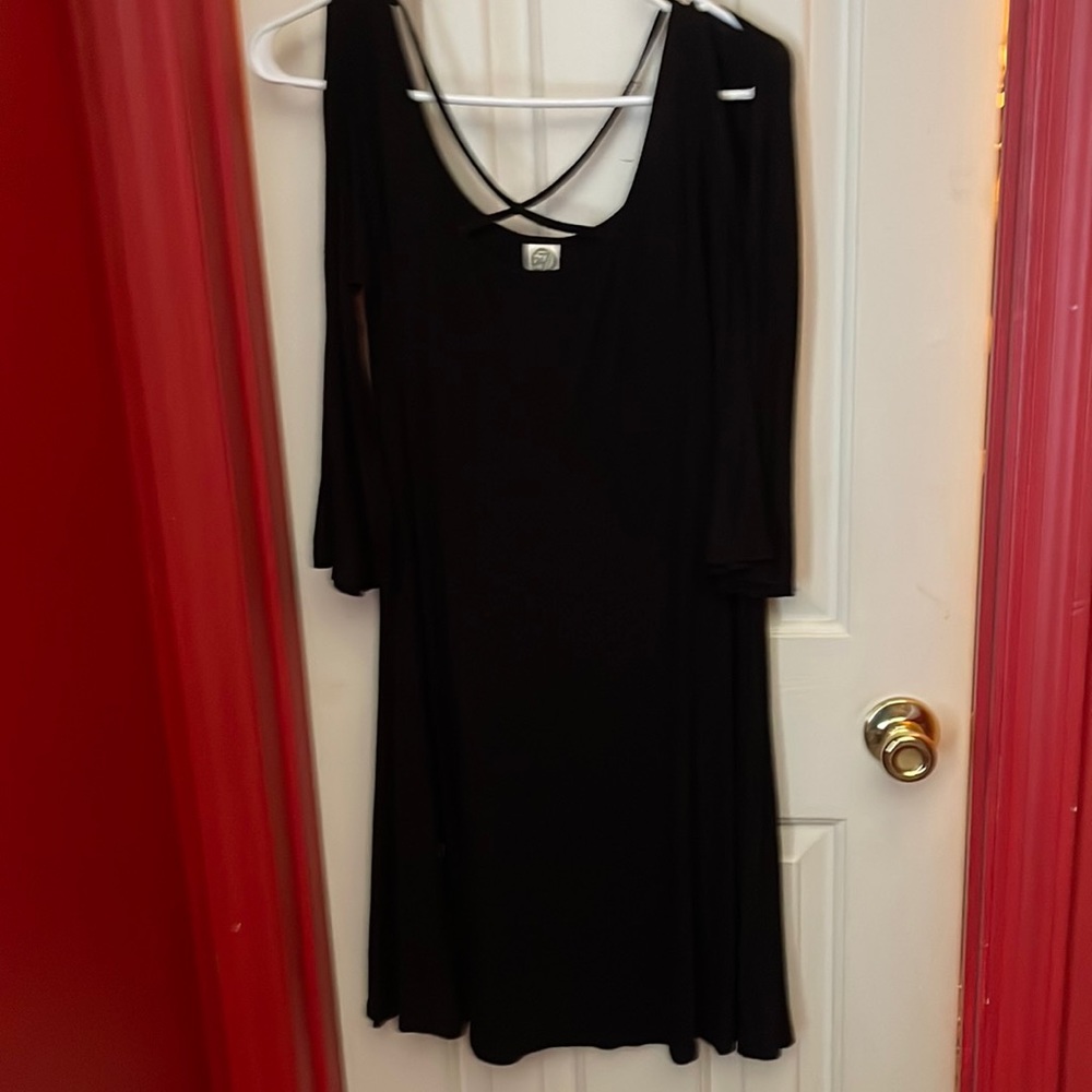 This is a cold shoulder dress with medium length sleeves